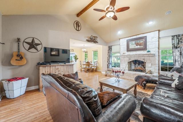 living room featuring vaulted ceiling with beams, light wood-style flooring, ceiling fan with notable chandelier, and baseboards