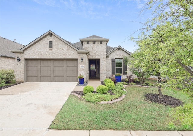 3004 Culver Ave, Celina, TX 75009 - french country inspired facade with driveway, brick siding, a front lawn, an attached garage, and a shingled roof