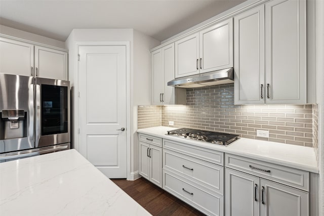 3004 Culver Ave, Celina, TX 75009 - kitchen featuring light stone counters, stainless steel appliances, decorative backsplash, under cabinet range hood, and dark wood-style floors