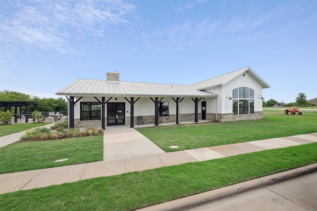 3004 Culver Ave, Celina, TX 75009 - view of front of home featuring a standing seam roof, a chimney, a front lawn, and metal roof