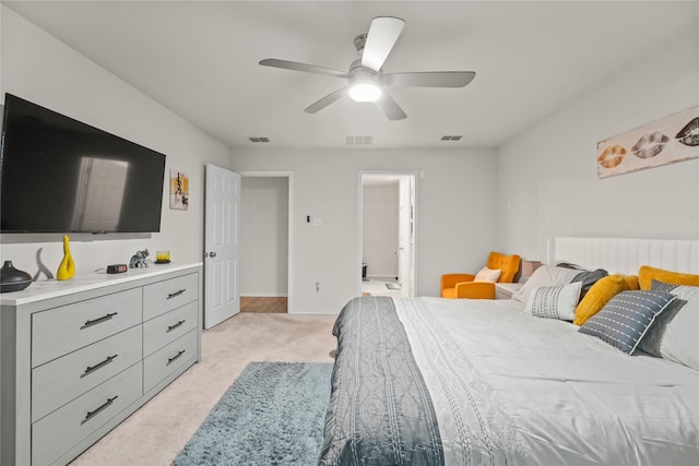 bedroom featuring ceiling fan, light colored carpet, and visible vents