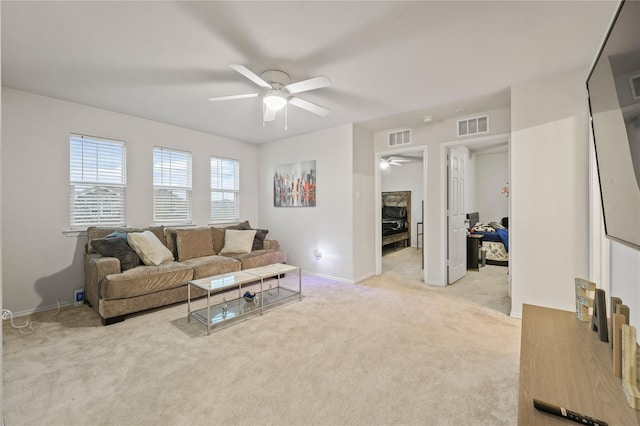 living room with ceiling fan, light colored carpet, and visible vents