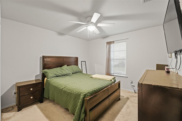 bedroom featuring baseboards, ceiling fan, and light carpet