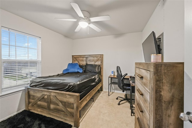 bedroom featuring ceiling fan and light carpet
