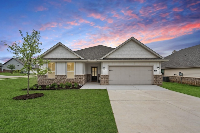 craftsman inspired home with a garage, a lawn, driveway, and brick siding
