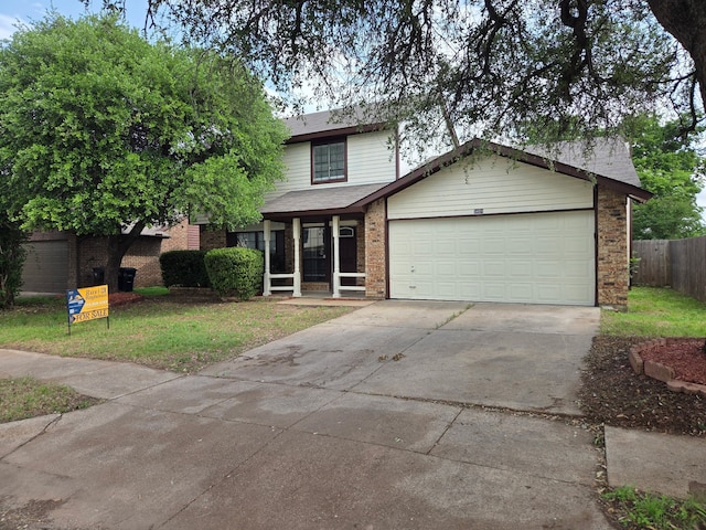 view of front of property featuring driveway, brick siding, fence, a front lawn, and an attached garage