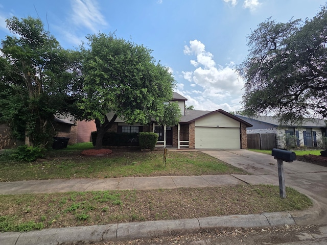 view of front of house featuring driveway, brick siding, fence, a front lawn, and an attached garage