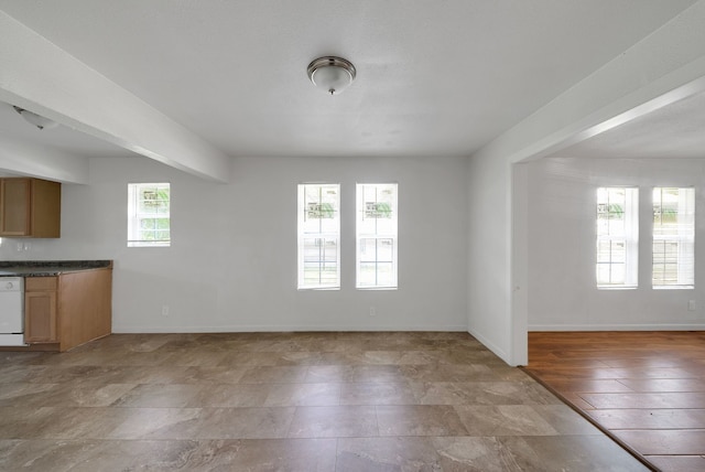 unfurnished living room featuring baseboards
