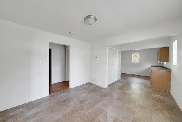 empty room featuring a sink and visible vents