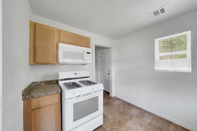 kitchen featuring white appliances, baseboards, visible vents, and light brown cabinets