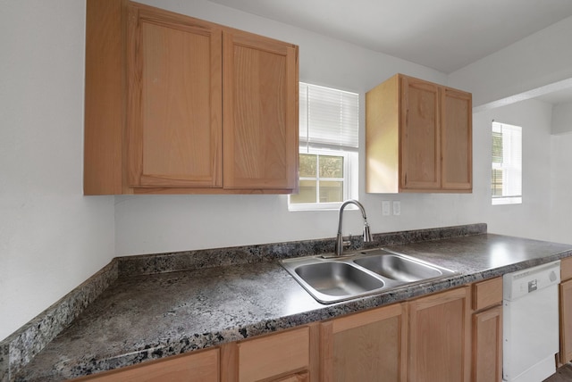 kitchen featuring a sink, dark countertops, light brown cabinetry, and dishwasher