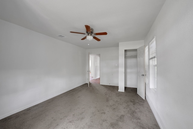 unfurnished bedroom with visible vents, carpet floors, a closet, baseboards, and ceiling fan