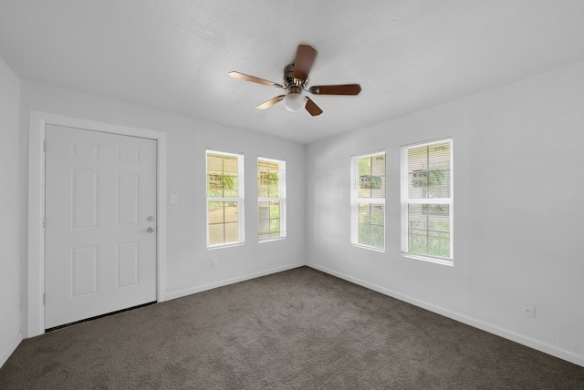 unfurnished room with baseboards, a ceiling fan, and carpet flooring