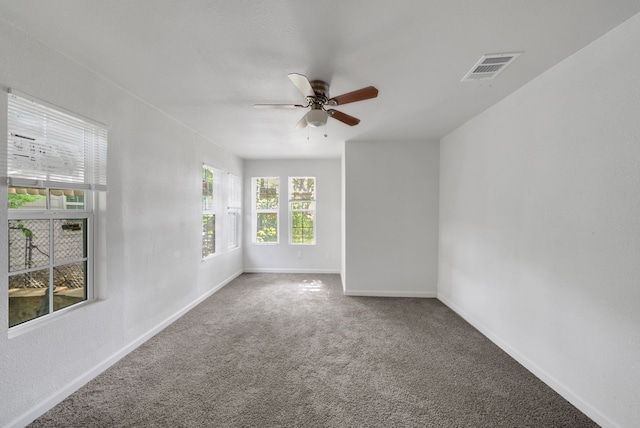 unfurnished room with a ceiling fan, baseboards, visible vents, and carpet