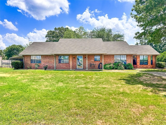 104 W Perry St, Frankston, TX 75763 - ranch-style home with brick siding, a front yard, and a carport