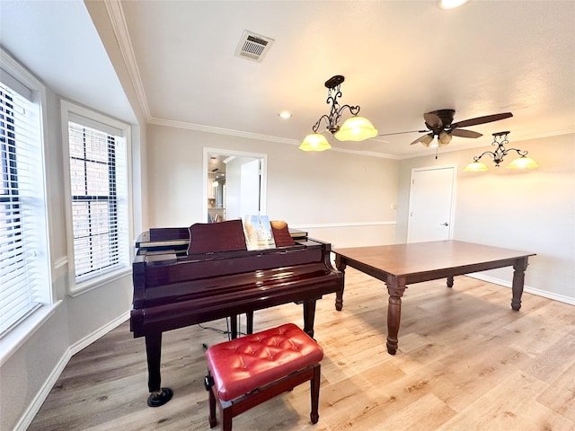 104 W Perry St, Frankston, TX 75763 - living area with visible vents, crown molding, light wood-style floors, baseboards, and a ceiling fan