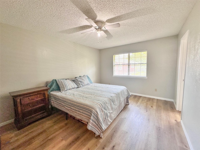 104 W Perry St, Frankston, TX 75763 - bedroom with baseboards, ceiling fan, a textured ceiling, and light wood-style flooring