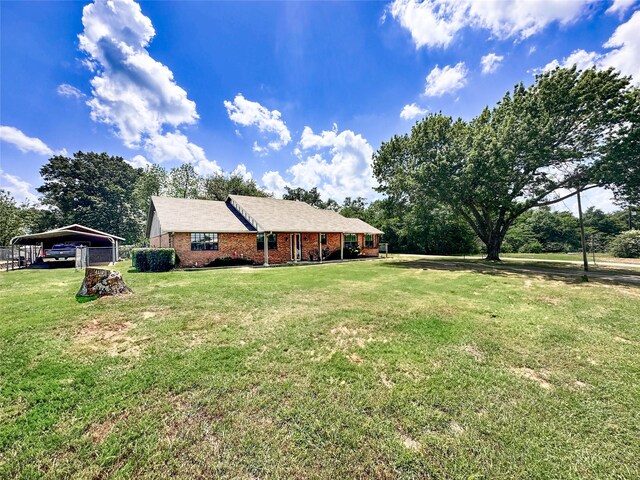 104 W Perry St, Frankston, TX 75763 - exterior space featuring a detached carport, brick siding, and a front yard