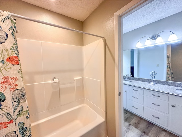 104 W Perry St, Frankston, TX 75763 - bathroom with shower / tub combo, vanity, a textured ceiling, and wood finished floors