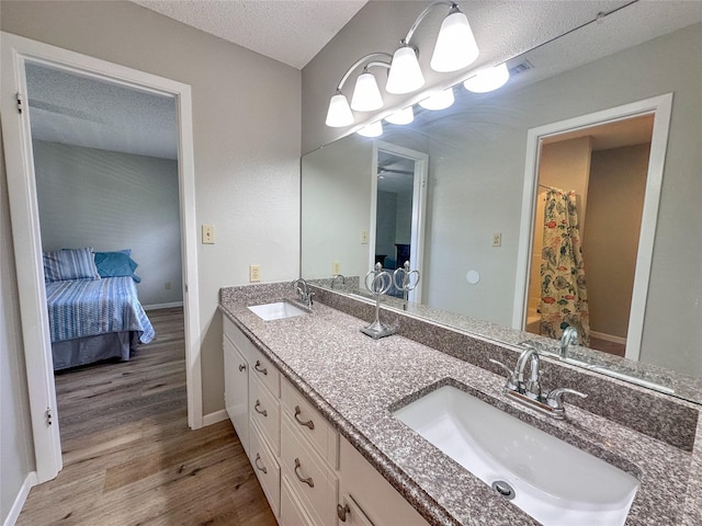 104 W Perry St, Frankston, TX 75763 - ensuite bathroom with baseboards, a sink, wood finished floors, and double vanity