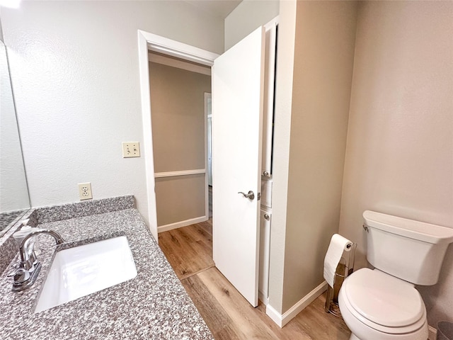104 W Perry St, Frankston, TX 75763 - half bath with toilet, baseboards, a sink, and wood finished floors