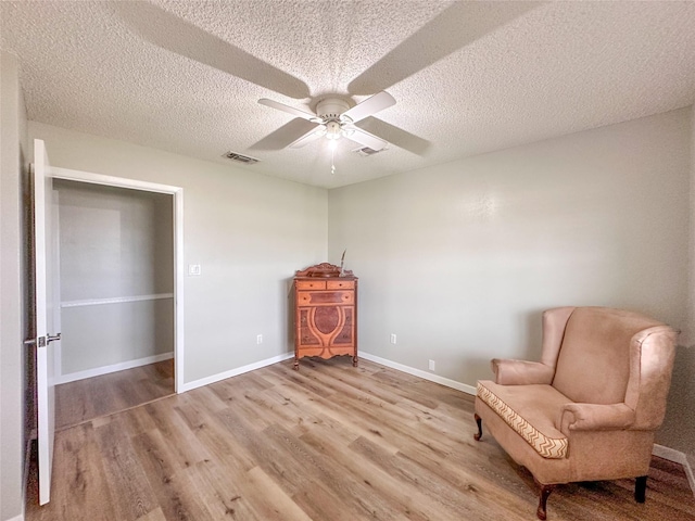 104 W Perry St, Frankston, TX 75763 - sitting room with ceiling fan, light wood-type flooring, a textured ceiling, and visible vents