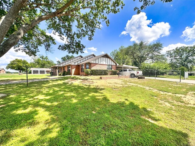 104 W Perry St, Frankston, TX 75763 - view of front of home with brick siding, a front lawn, board and batten siding, and fence