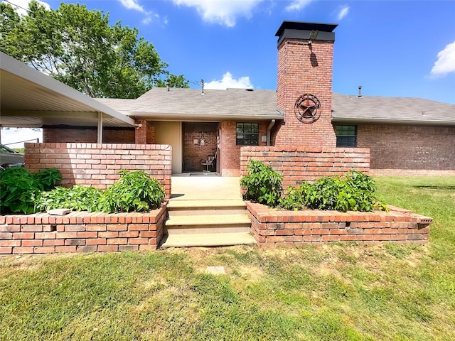 104 W Perry St, Frankston, TX 75763 - view of exterior entry featuring a lawn, a chimney, roof with shingles, and brick siding
