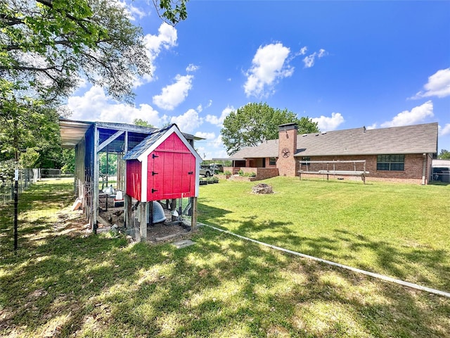 104 W Perry St, Frankston, TX 75763 - view of yard with exterior structure, fence, and an outbuilding