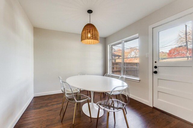 dining room featuring dark wood-style flooring and baseboards