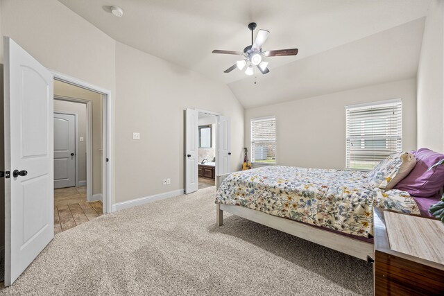 bedroom featuring multiple windows, baseboards, light carpet, and lofted ceiling