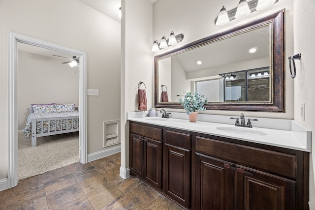 bathroom featuring a sink, stone finish floor, ensuite bath, and double vanity