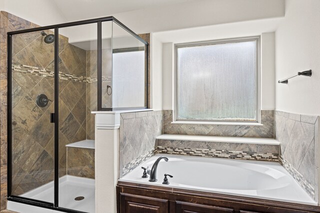 bathroom with a shower stall and a garden tub