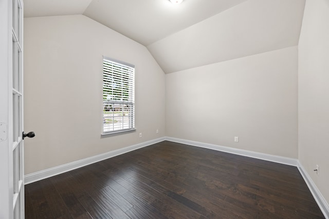 bonus room featuring dark wood-style flooring, baseboards, and lofted ceiling