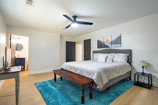 bedroom with visible vents, a ceiling fan, light wood-style floors, and baseboards