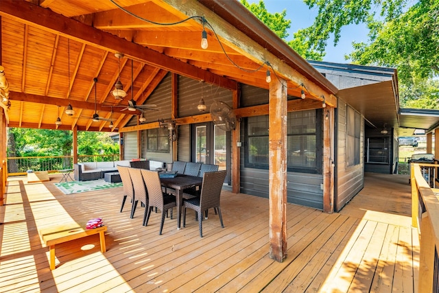wooden deck featuring outdoor lounge area, a ceiling fan, and outdoor dining area