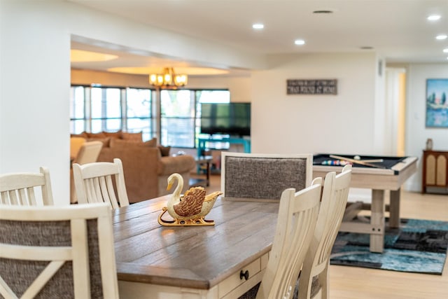 dining space featuring recessed lighting, a chandelier, and wood finished floors