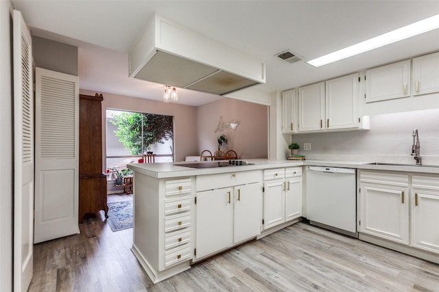 kitchen with dishwasher, a sink, white cabinets, light wood finished floors, and a peninsula