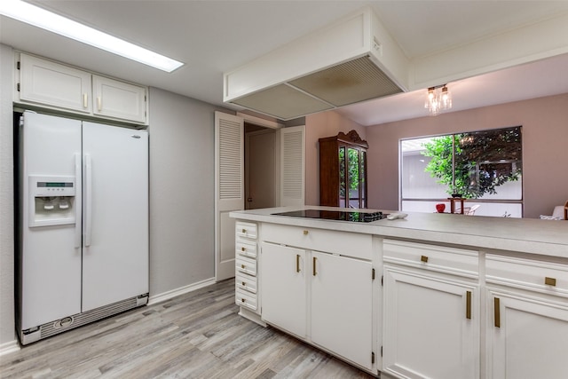 kitchen with black electric cooktop, white cabinetry, white refrigerator with ice dispenser, and light wood finished floors