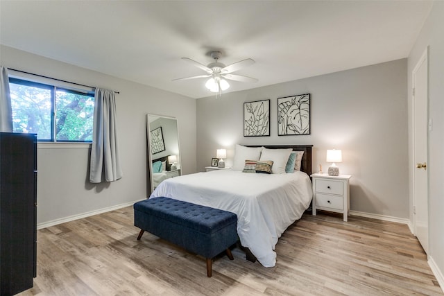 bedroom with baseboards, a ceiling fan, and light wood-style flooring