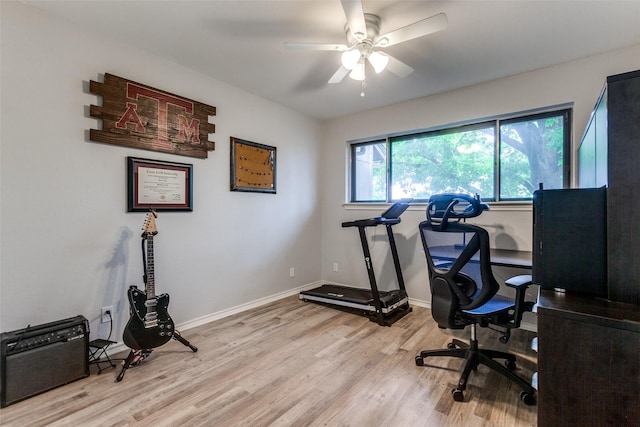 office area with light wood-style floors, baseboards, and a ceiling fan