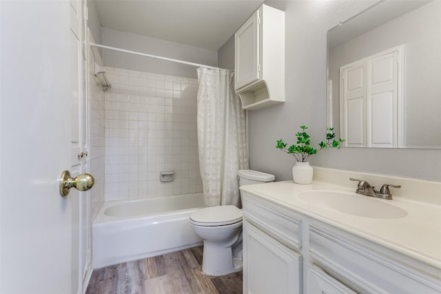 full bathroom featuring shower / bath combo with shower curtain, wood finished floors, toilet, and vanity