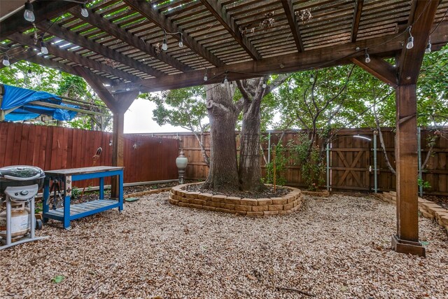 view of yard featuring a pergola, a gate, and a fenced backyard