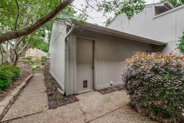 view of outbuilding featuring a gate