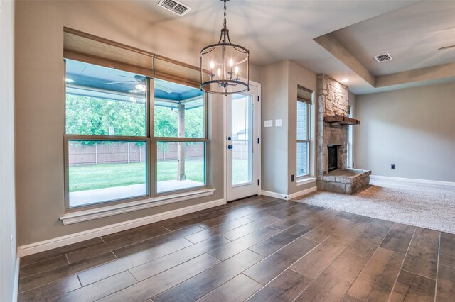 unfurnished living room with dark wood-style flooring, baseboards, and visible vents