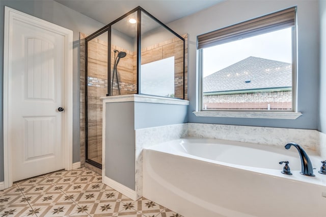 bathroom with a stall shower and a garden tub
