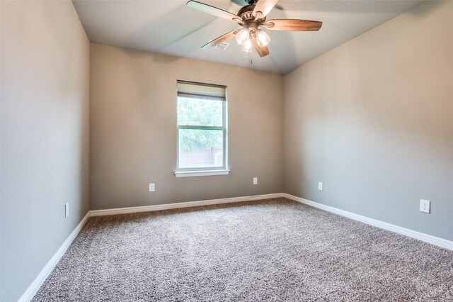 unfurnished room with a ceiling fan, baseboards, visible vents, and carpet