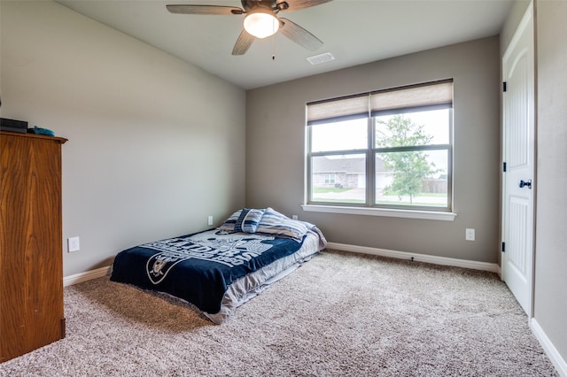 bedroom with visible vents, carpet flooring, baseboards, and a ceiling fan