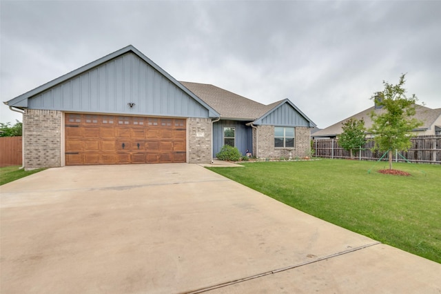 craftsman-style home featuring fence, a front lawn, a garage, board and batten siding, and concrete driveway