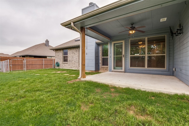 view of yard featuring ceiling fan, a patio area, and fence